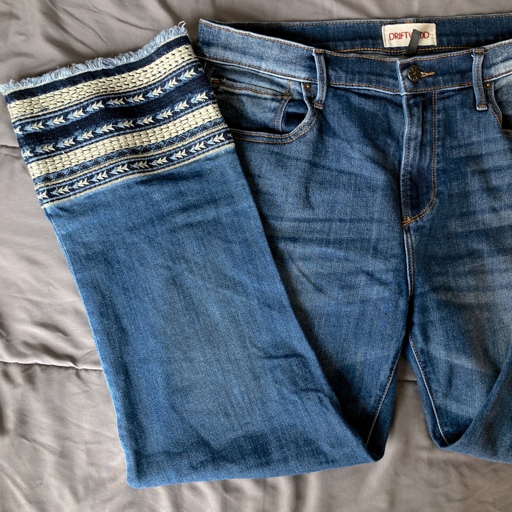 Blue jeans with embroidered detailing on the bottom